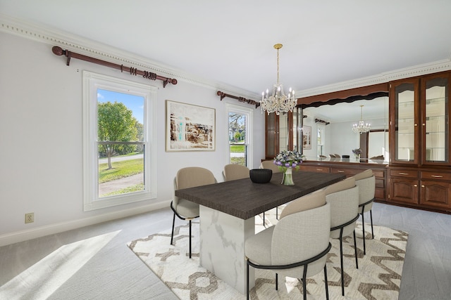 dining space with a chandelier, light hardwood / wood-style flooring, and ornamental molding