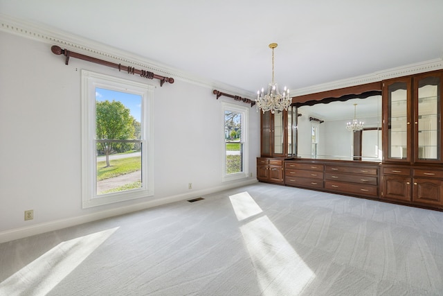 interior space featuring light carpet, ornamental molding, and a notable chandelier