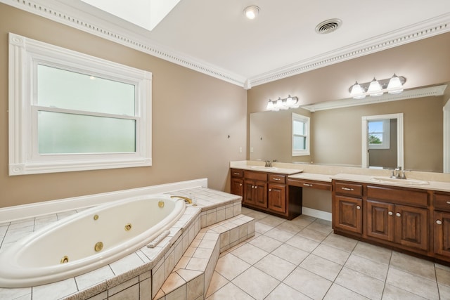 bathroom with a skylight, vanity, crown molding, tiled tub, and tile patterned flooring