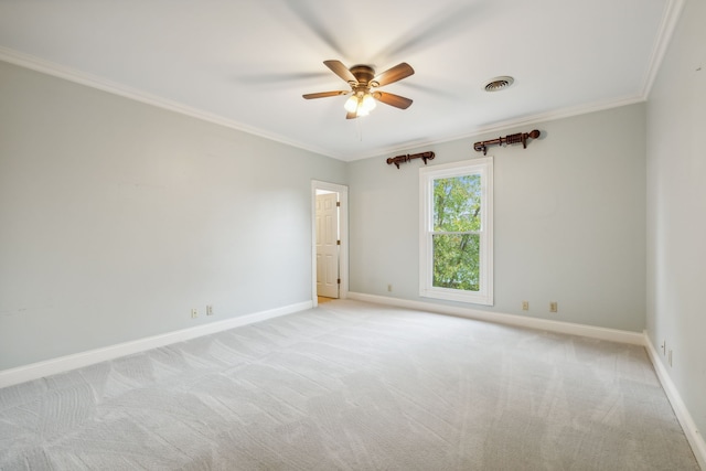 spare room featuring ceiling fan, ornamental molding, and light carpet