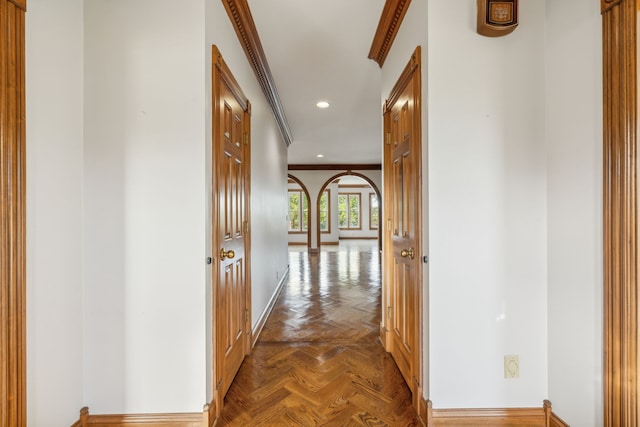 hall featuring dark parquet floors and ornamental molding