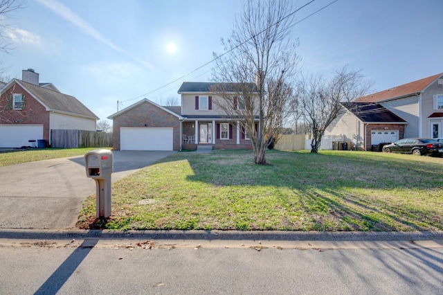 view of property featuring a garage and a front yard