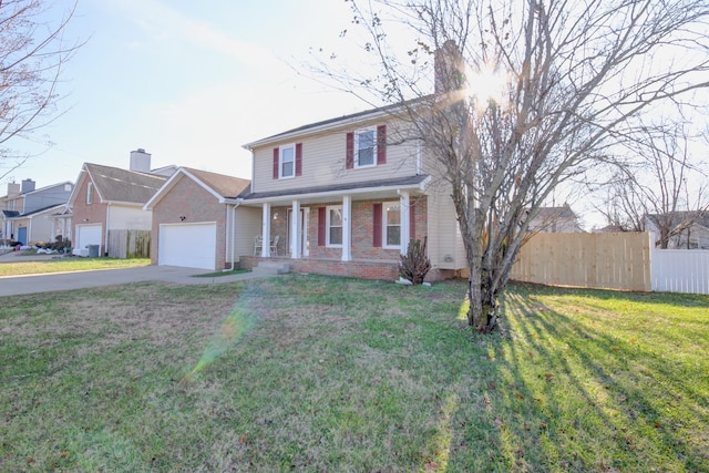 view of front facade with a garage, a porch, and a front yard