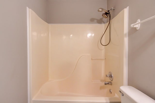 bathroom featuring toilet and washtub / shower combination