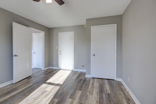 unfurnished bedroom featuring hardwood / wood-style flooring and ceiling fan