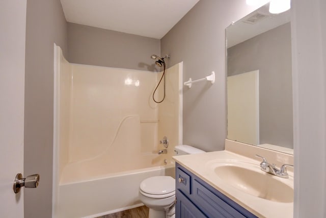 full bathroom featuring hardwood / wood-style floors, vanity, bathtub / shower combination, and toilet