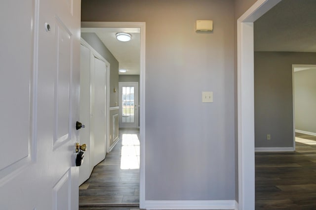 hall with dark hardwood / wood-style flooring