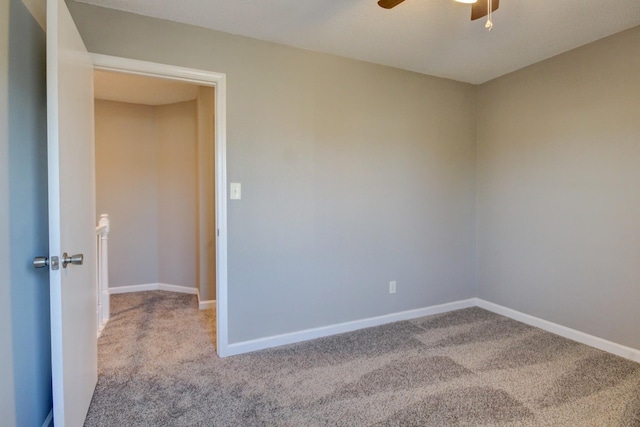 empty room with light colored carpet and ceiling fan