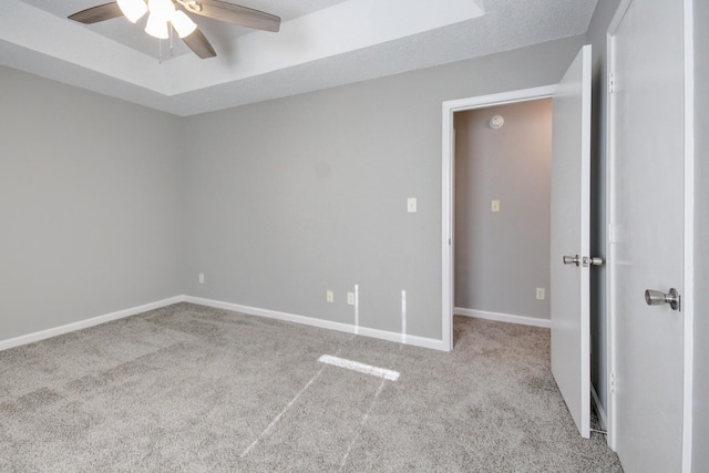 carpeted spare room with ceiling fan and a textured ceiling