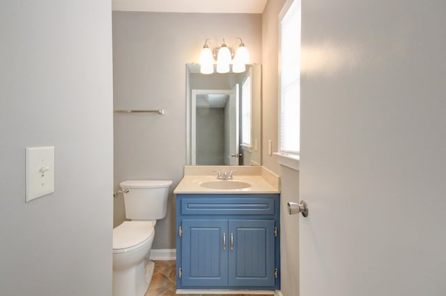 bathroom with tile patterned flooring, vanity, and toilet