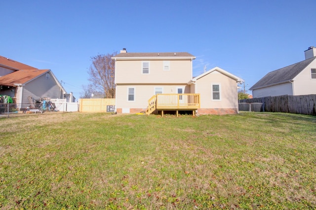 back of property with a lawn and a wooden deck