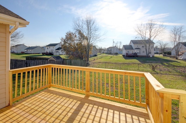 wooden deck featuring a lawn