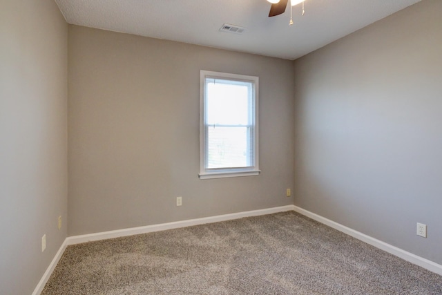 empty room with ceiling fan and carpet