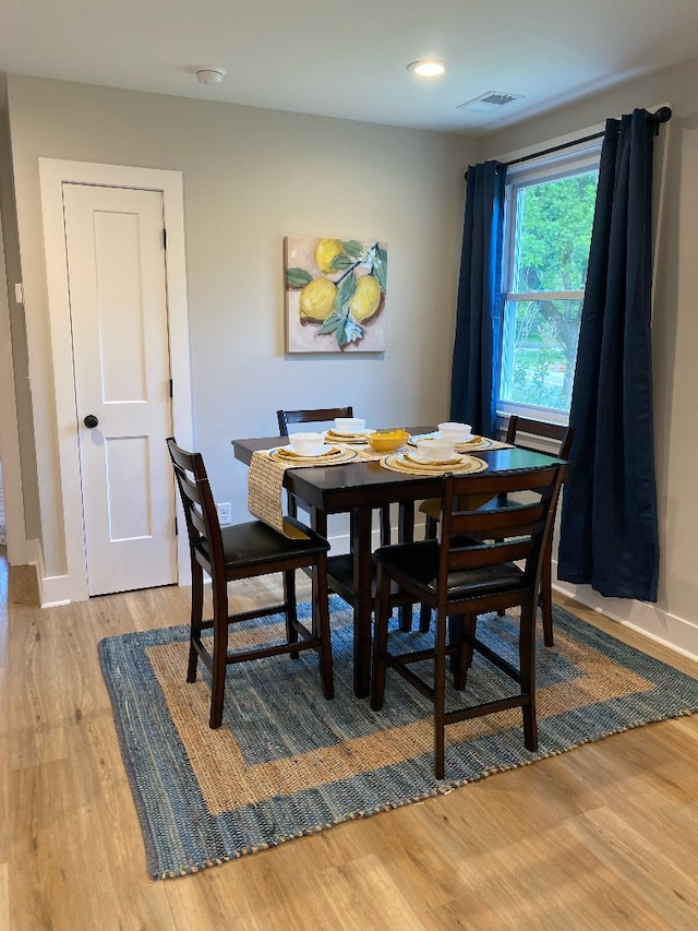 dining space with hardwood / wood-style floors