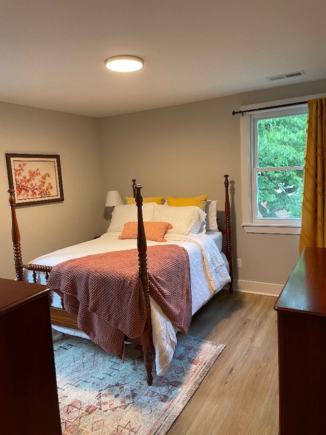 bedroom with wood-type flooring