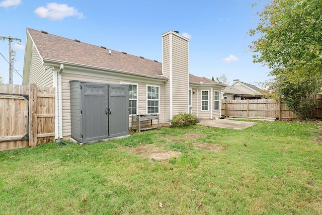 rear view of house with a patio, a storage shed, and a lawn