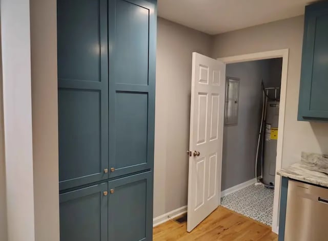 interior space featuring electric water heater and light hardwood / wood-style flooring