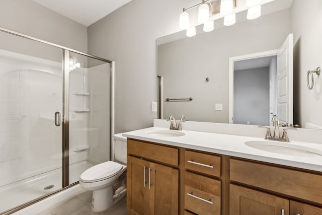 bathroom featuring tile patterned floors, vanity, an enclosed shower, and toilet