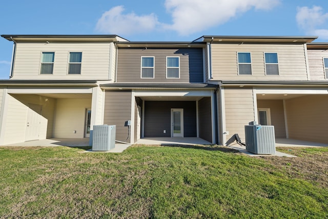 rear view of property featuring a yard, a patio, and central AC unit