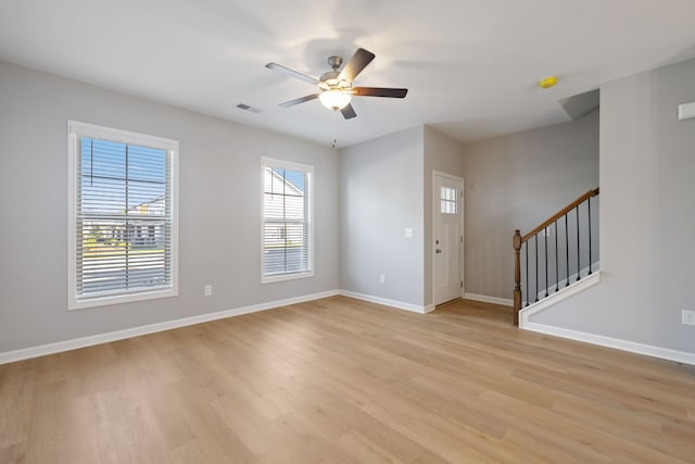 entrance foyer with ceiling fan and light hardwood / wood-style flooring