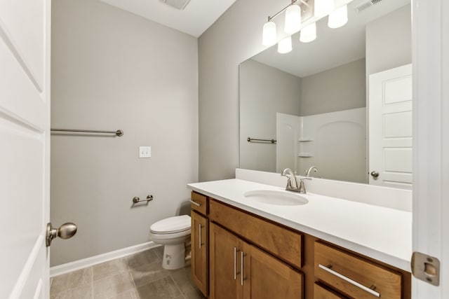 bathroom featuring a shower, tile patterned floors, vanity, and toilet