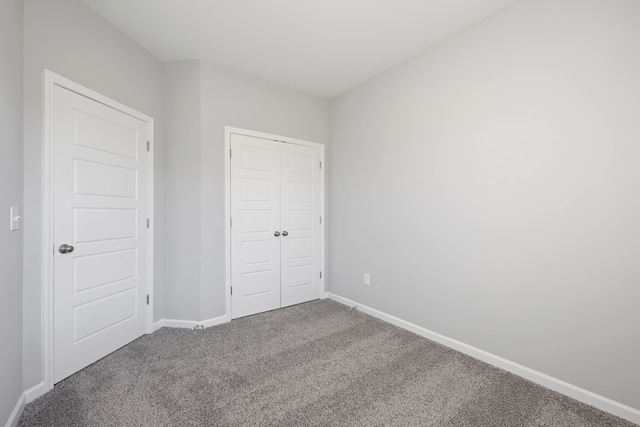 unfurnished bedroom with carpet floors and a closet