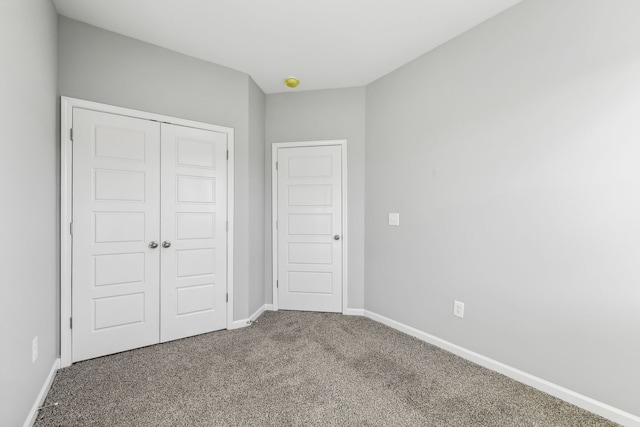 unfurnished bedroom with carpet floors and a closet