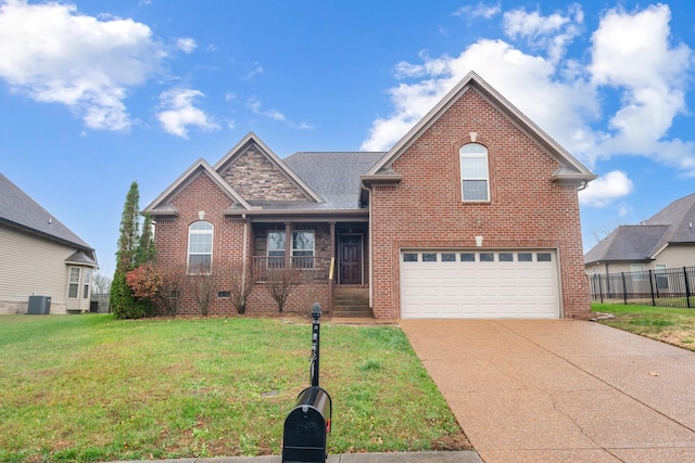 front facade with a porch, a garage, a front lawn, and cooling unit