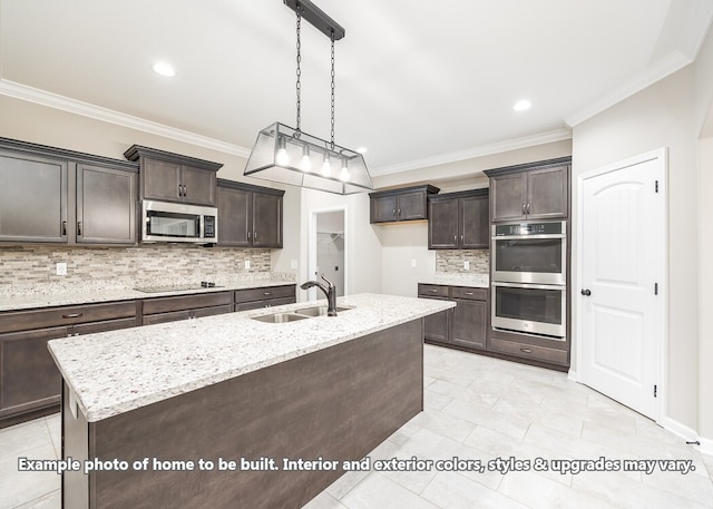 kitchen featuring sink, ornamental molding, a center island with sink, and appliances with stainless steel finishes