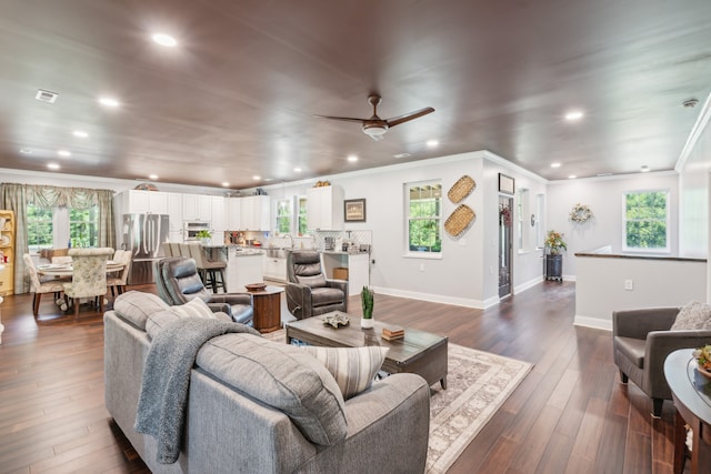 living room with ceiling fan, a healthy amount of sunlight, sink, and dark hardwood / wood-style floors