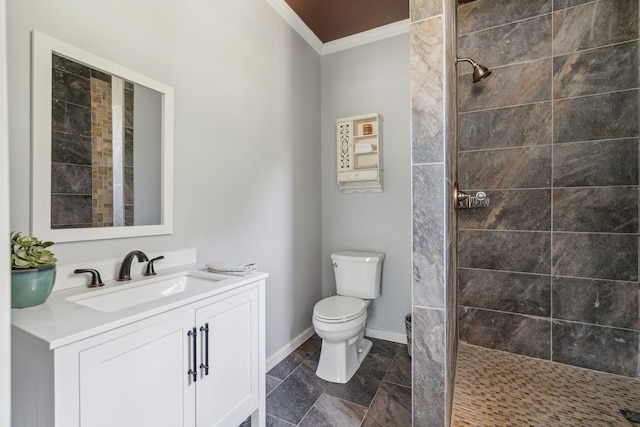 bathroom with toilet, a tile shower, ornamental molding, and vanity