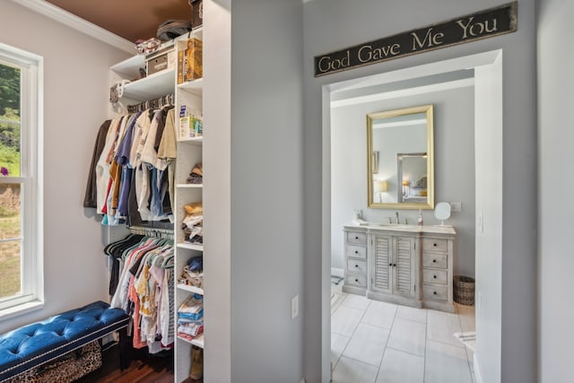 spacious closet featuring light tile patterned flooring and sink