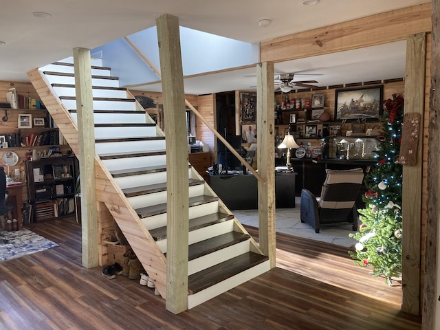 staircase featuring ceiling fan and hardwood / wood-style flooring