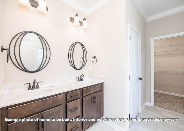 full bath with double vanity, ornamental molding, a sink, and a walk in closet