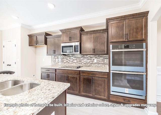 kitchen with tasteful backsplash, crown molding, stainless steel appliances, and a sink