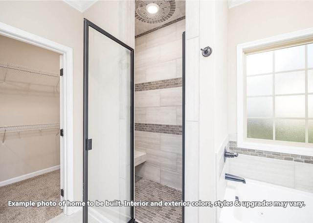 full bathroom with a spacious closet, a shower stall, and a bath