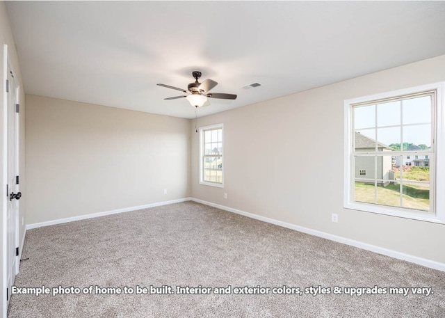 empty room featuring ceiling fan, carpet flooring, visible vents, and baseboards