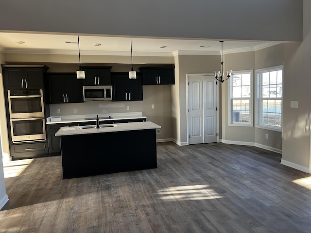 kitchen with stainless steel appliances, light countertops, and dark cabinets