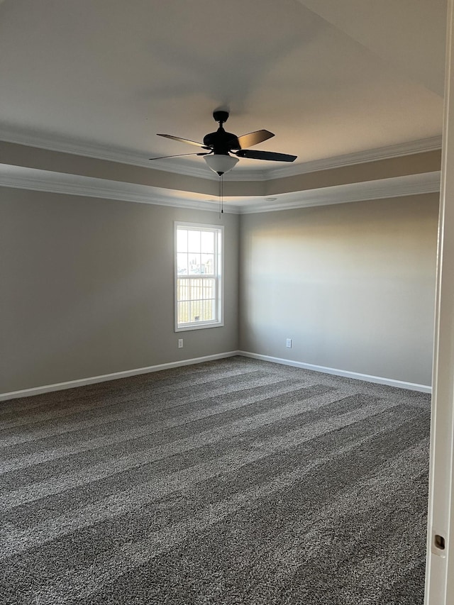 spare room featuring carpet floors, baseboards, and crown molding