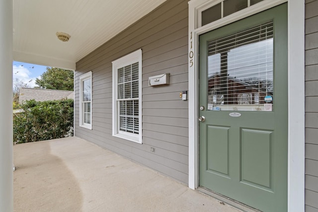 view of exterior entry featuring a porch