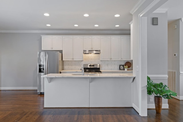 kitchen with dark hardwood / wood-style floors, white cabinetry, ornamental molding, and appliances with stainless steel finishes