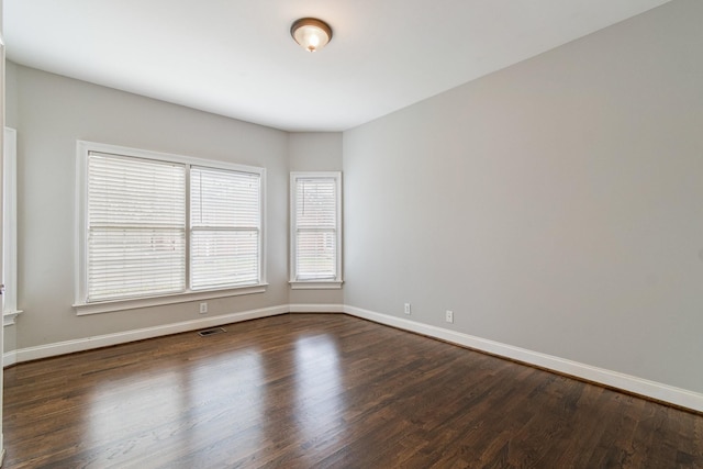 spare room with dark hardwood / wood-style floors