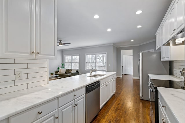 kitchen featuring white cabinetry, sink, dark hardwood / wood-style floors, decorative backsplash, and appliances with stainless steel finishes