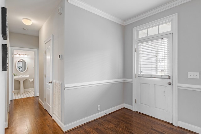 foyer entrance featuring dark hardwood / wood-style flooring and ornamental molding