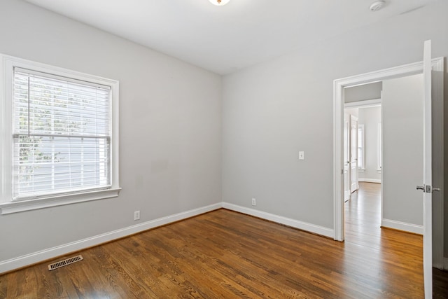 spare room with dark wood-type flooring