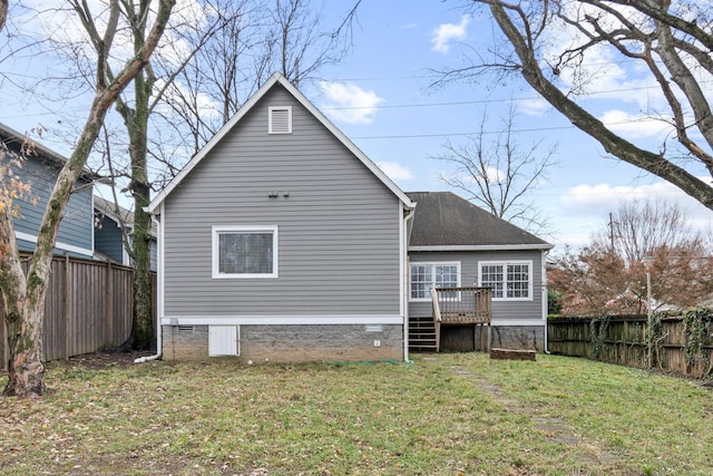 back of house featuring a yard and a wooden deck