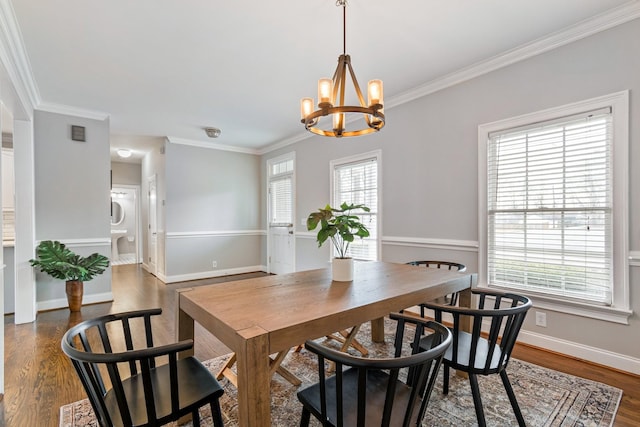 dining room featuring dark hardwood / wood-style flooring, a wealth of natural light, and crown molding