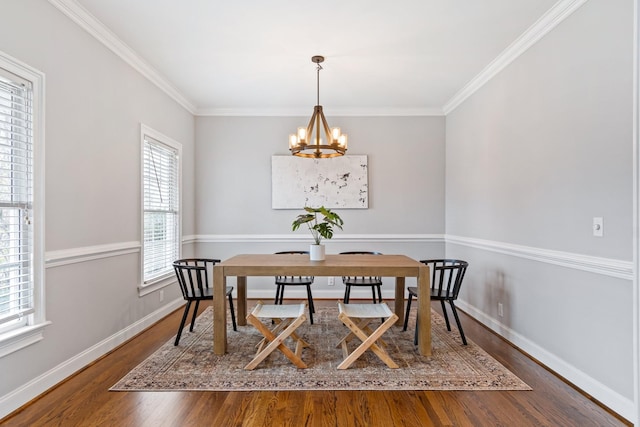 dining room with dark hardwood / wood-style flooring, crown molding, and plenty of natural light