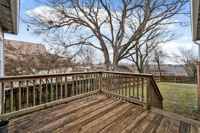 wooden terrace featuring a yard