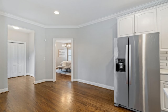 kitchen featuring white cabinetry, dark hardwood / wood-style flooring, crown molding, and stainless steel refrigerator with ice dispenser